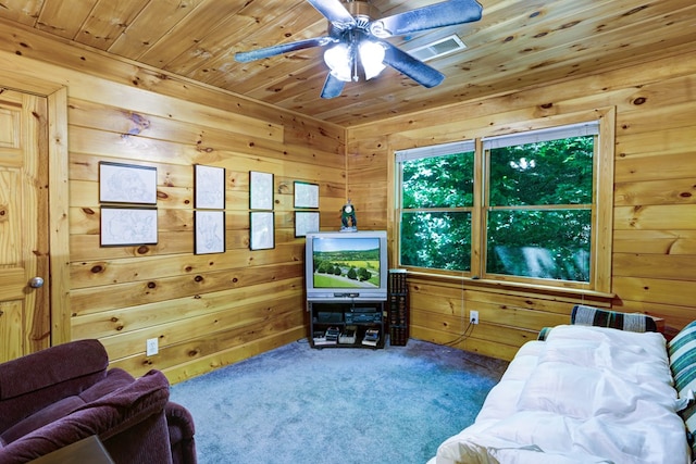 carpeted living room with wood walls and wood ceiling