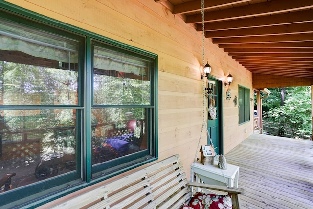 wooden terrace featuring covered porch