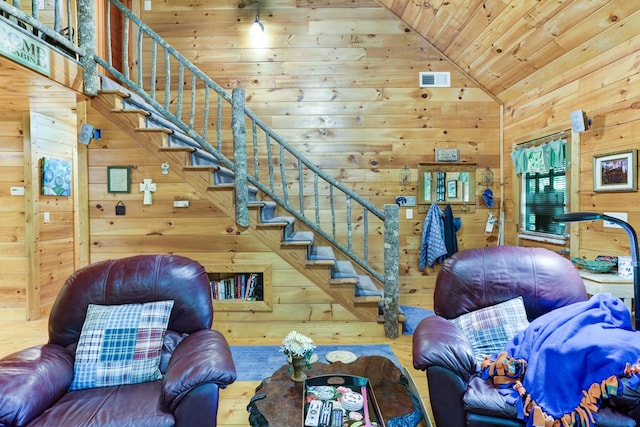 living room featuring hardwood / wood-style flooring, wooden ceiling, wooden walls, and vaulted ceiling