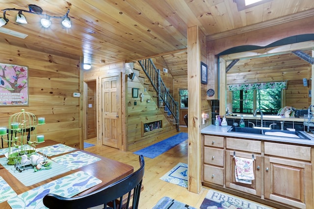 interior space with vanity, wooden ceiling, wooden walls, a skylight, and hardwood / wood-style flooring