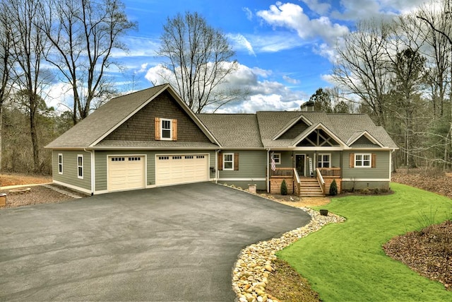 craftsman-style home with a garage, a front lawn, and a porch