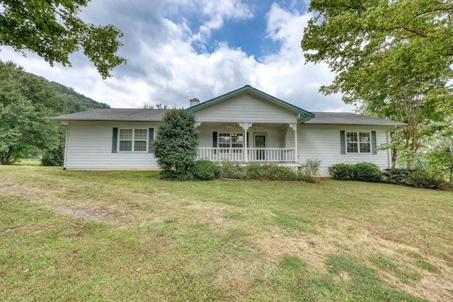 ranch-style house featuring a front yard and covered porch