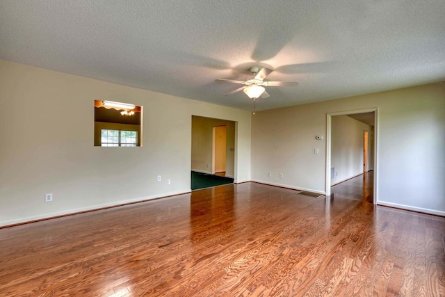 empty room with hardwood / wood-style flooring, a textured ceiling, and ceiling fan