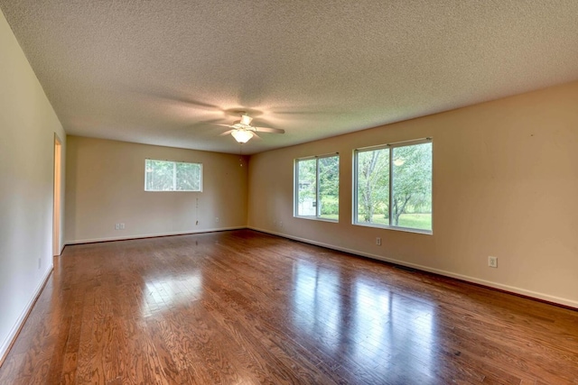 unfurnished room with ceiling fan, wood-type flooring, and a textured ceiling