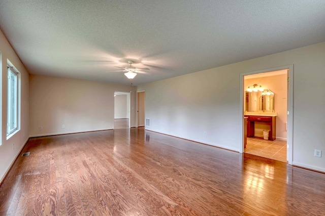 spare room featuring ceiling fan, a textured ceiling, and light hardwood / wood-style floors