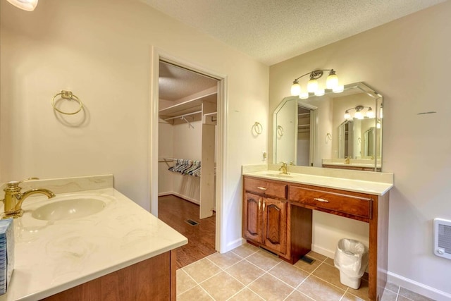 bathroom featuring tile patterned flooring, a textured ceiling, and vanity