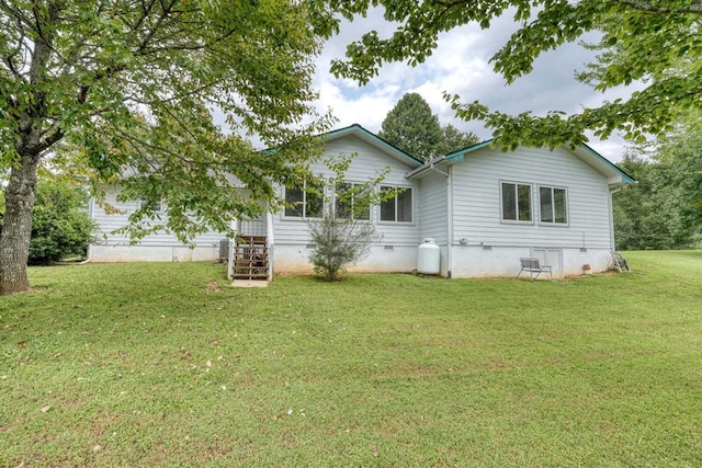 back of property featuring a lawn