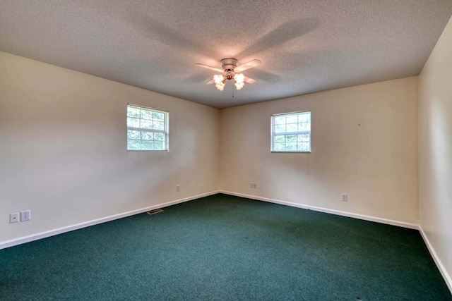 carpeted spare room featuring ceiling fan and a textured ceiling