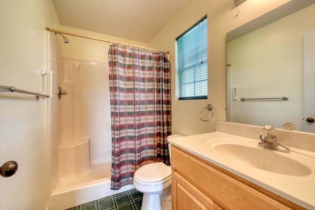 bathroom featuring tile patterned flooring, toilet, a textured ceiling, and vanity