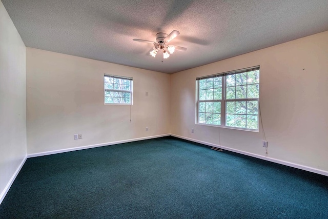 spare room featuring ceiling fan, carpet flooring, and a textured ceiling