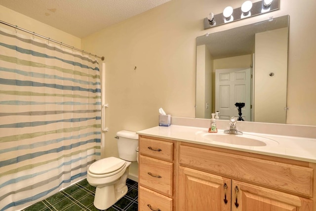 bathroom featuring tile patterned floors, a textured ceiling, vanity, and toilet