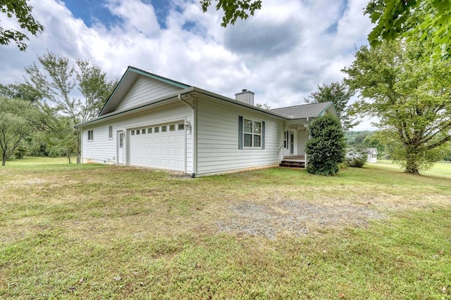 view of side of home with a lawn and a garage