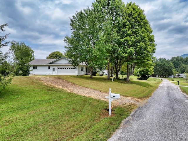 view of front of house featuring a front yard and a garage