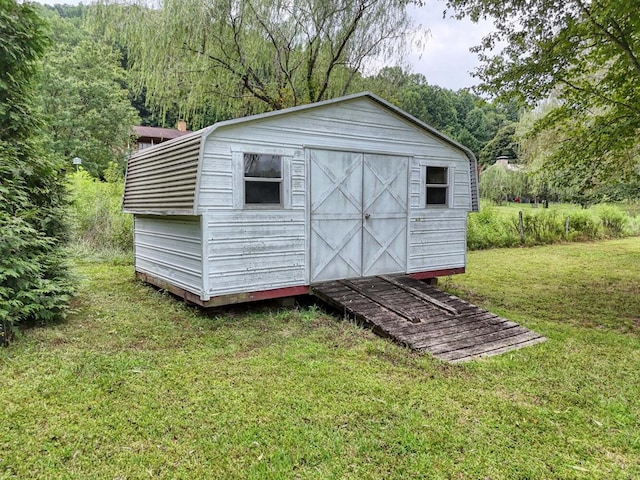 view of outdoor structure featuring a lawn