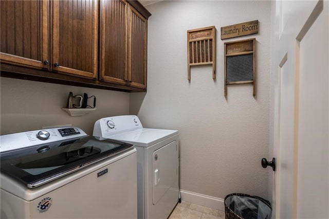 washroom featuring cabinet space, independent washer and dryer, and baseboards