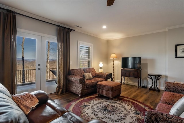 living area featuring visible vents, a mountain view, crown molding, and french doors