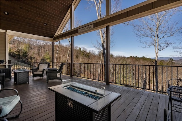 wooden deck with an outdoor living space with a fire pit