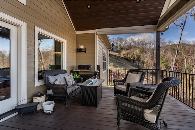 wooden terrace featuring an outdoor hangout area