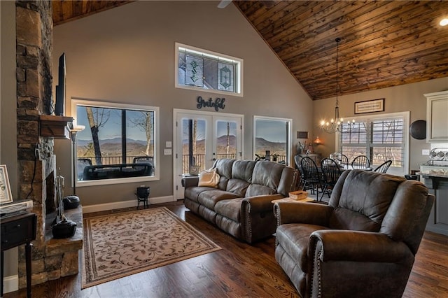 living area featuring a chandelier, dark wood-style flooring, wooden ceiling, and french doors