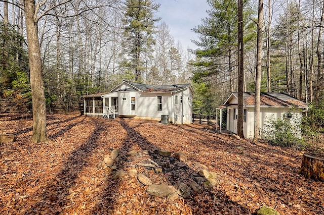 view of front of house with a sunroom and an outdoor structure