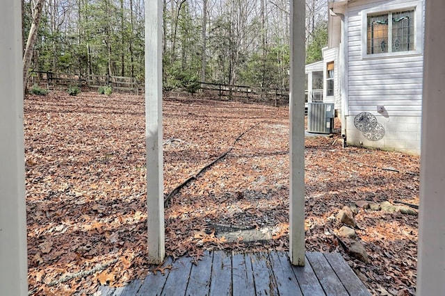 view of yard with fence and central AC unit