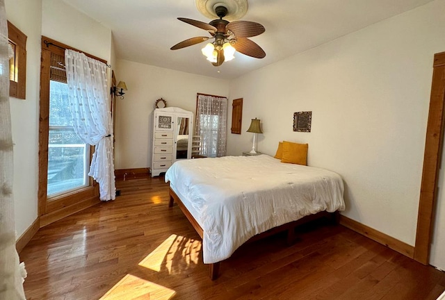 bedroom featuring wood finished floors and baseboards