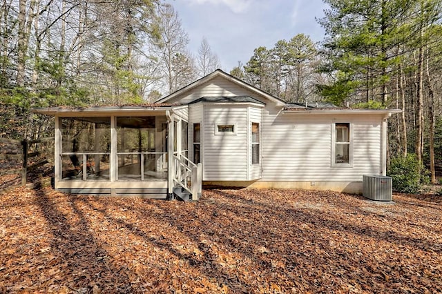 back of house with a sunroom and central AC