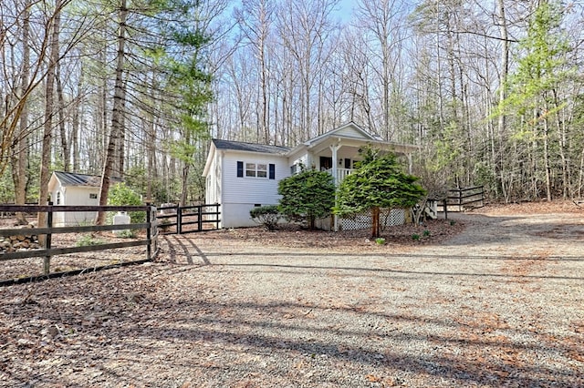 exterior space with driveway, a gate, and fence