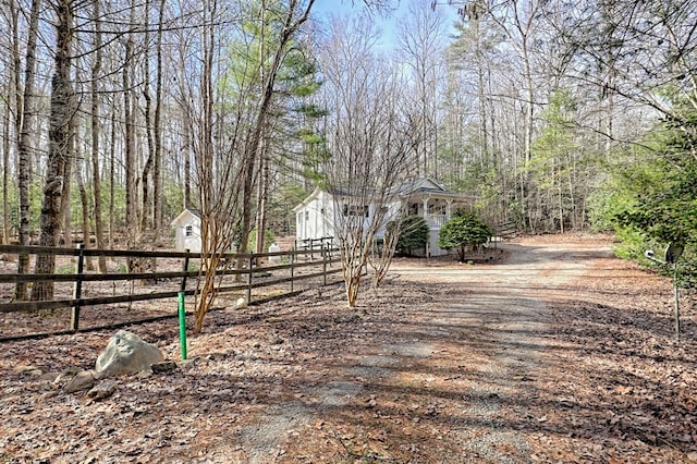 view of street with dirt driveway