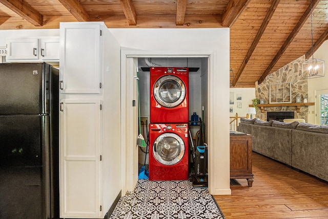 147 Hester Gap Rd, Cleveland, GA 30528 - washroom featuring stacked washer / drying machine, wood ceiling, light wood-style floors, and a fireplace