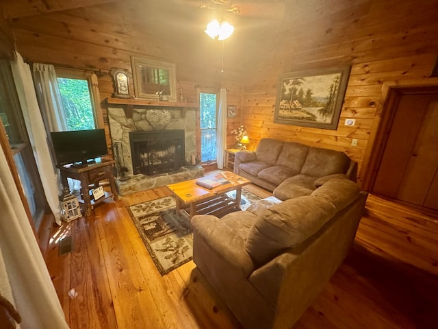 135 Tomahawk Trl, Blue Ridge, GA 30513 - living room with hardwood / wood-style floors, a stone fireplace, and wooden walls