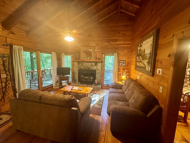 135 Tomahawk Trl, Blue Ridge, GA 30513 - living room featuring wood walls, hardwood / wood-style flooring, healthy amount of natural light, a fireplace, and a ceiling fan