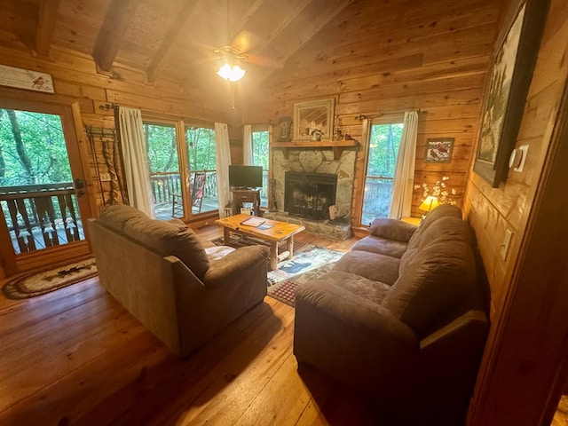 135 Tomahawk Trl, Blue Ridge, GA 30513 - living room with wooden walls, lofted ceiling, ceiling fan, light wood-style floors, and healthy amount of natural light