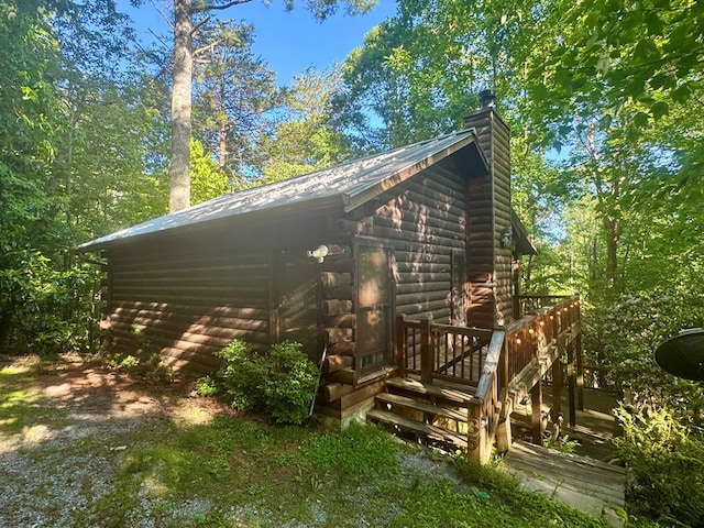 135 Tomahawk Trl, Blue Ridge, GA 30513 - view of side of property featuring a chimney, log exterior, metal roof, and a wooden deck