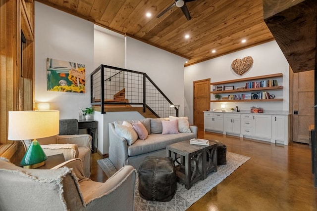 living room featuring ceiling fan, a towering ceiling, and wood ceiling