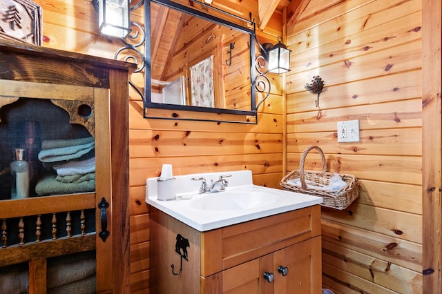 bathroom with vanity, wood walls, wood ceiling, and lofted ceiling with beams