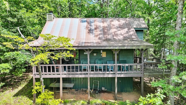 rear view of house featuring a wooden deck