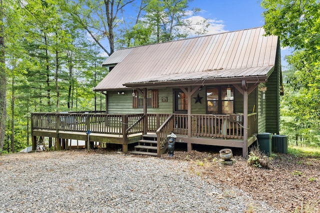 view of front facade featuring a wooden deck and central air condition unit