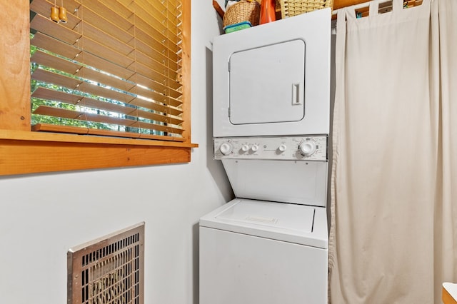 laundry area featuring stacked washer / dryer