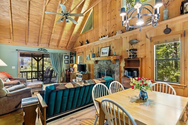 dining area featuring a fireplace, wooden ceiling, and beamed ceiling