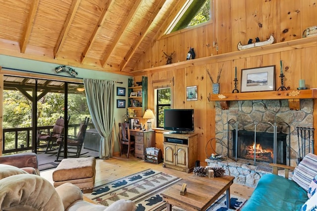 living room with wood ceiling, a stone fireplace, hardwood / wood-style flooring, high vaulted ceiling, and beam ceiling