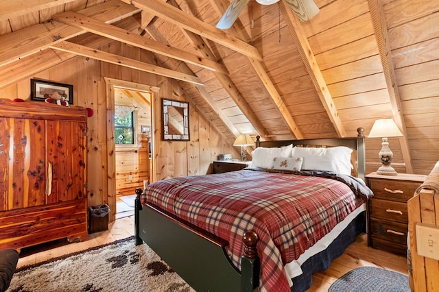 bedroom with wood ceiling, light hardwood / wood-style flooring, vaulted ceiling with beams, ceiling fan, and wood walls