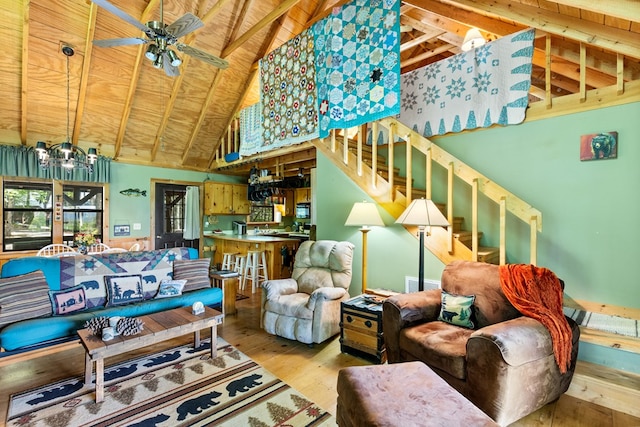 living room with hardwood / wood-style flooring, high vaulted ceiling, beam ceiling, and wood ceiling