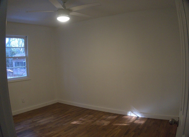 spare room featuring ceiling fan and dark hardwood / wood-style flooring