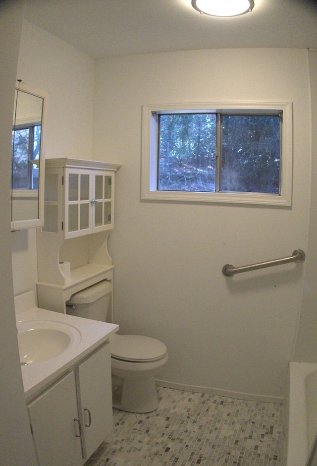 bathroom featuring tile patterned floors, vanity, and toilet