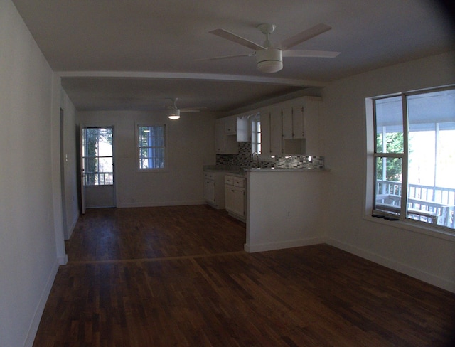 kitchen featuring white cabinets, ceiling fan, dark hardwood / wood-style flooring, and backsplash