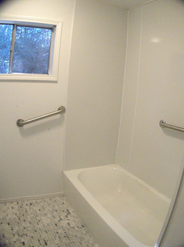 bathroom with tile patterned floors and a bathing tub