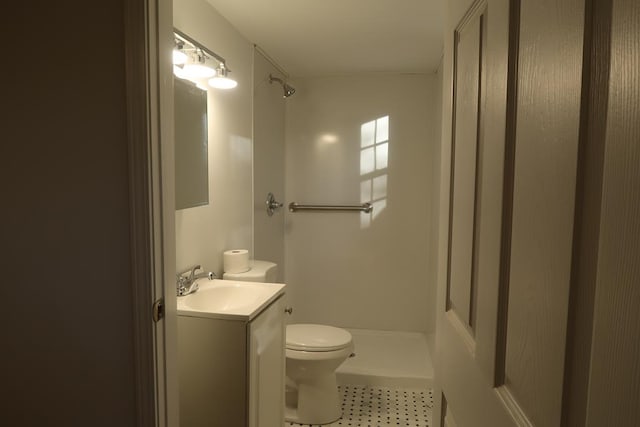 bathroom featuring tile patterned flooring, toilet, a shower, and vanity