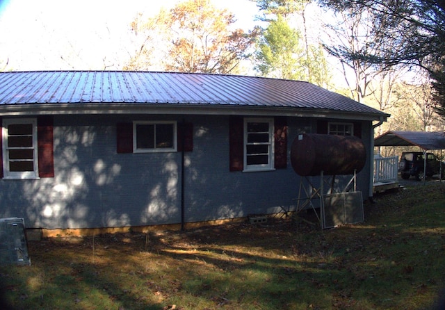 view of side of home with a carport