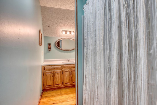 bathroom featuring hardwood / wood-style floors and vanity